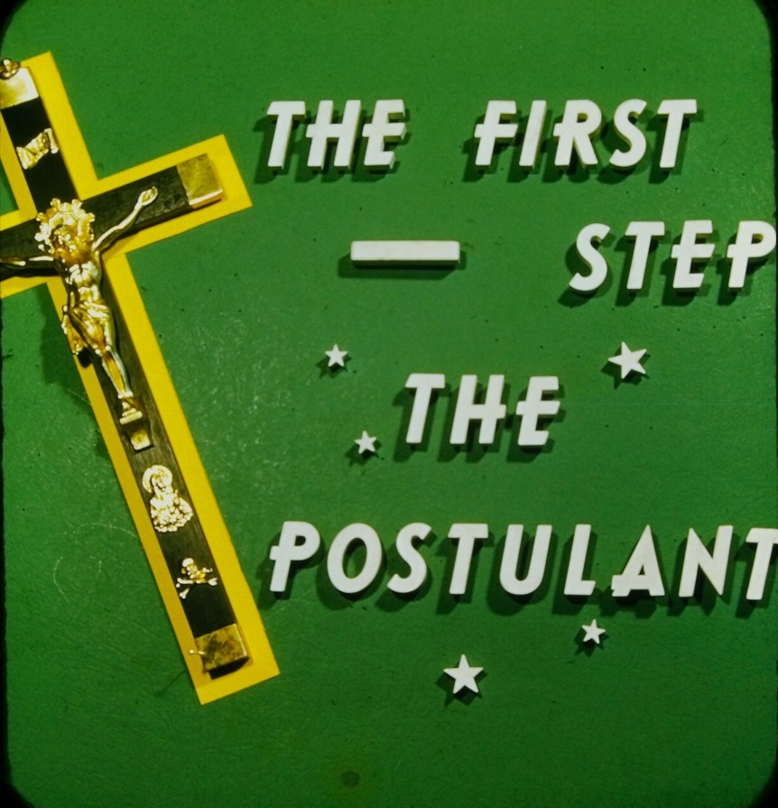 A crucifix next to the words: The First-Step the Postulant.