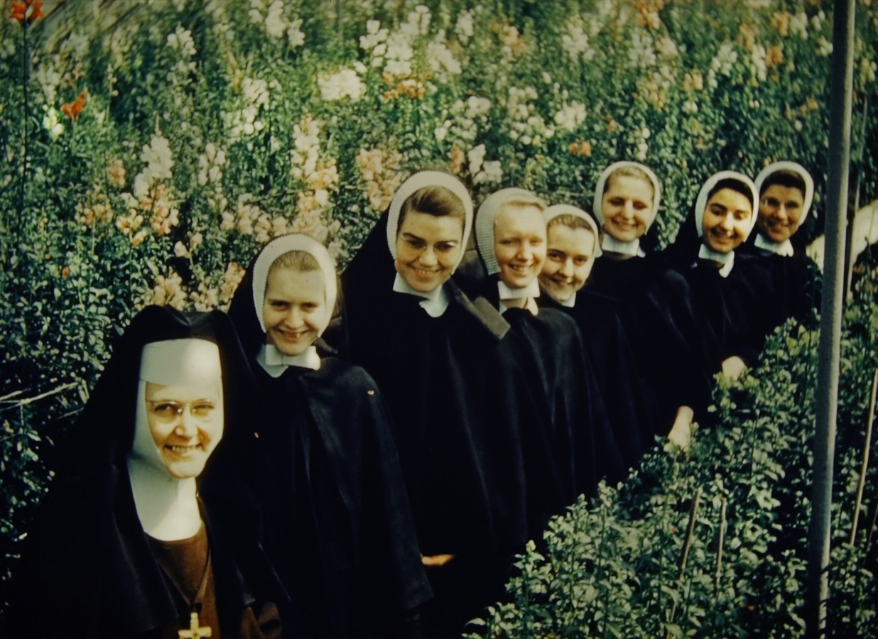 A group of young postulants with an older sister in the gardens.